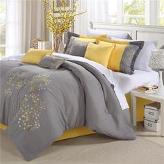 a bedroom with yellow and gray bedding