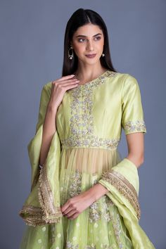 Lime green lehenga with with bandhani print and woven border. Comes with embroidered kurta with sheer panel and dupatta.
Components:3
Pattern:Print and Embroidery
Type of Work:Bandhani Print and Cutdana
Neckline:Round
Sleeve Type:Half
Fabric:Chanderi Silk and Tulle
Color:Green
Other Details:
Dupatta with embroidered border with fringe
Closure: Hook front
Occasion:Wedding - Aza Fashions Green Lehenga With Dori Work, Raw Silk Dress With Gota Work For Wedding, Raw Silk Wedding Dress With Gota Work, Wedding Dresses In Raw Silk With Gota Work, Traditional Green Palazzo Set For Reception, Green Art Silk Sets For Wedding, Green Floor-length Set With Zari Work, Floor-length Green Art Silk Sets, Green Floor-length Art Silk Set