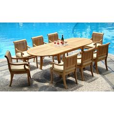 an outdoor dining table and chairs next to a swimming pool with a bottle of wine on it