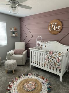 a baby's room with a crib, chair and rug