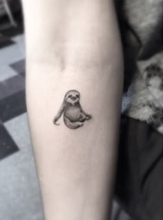 a small bird tattoo on the arm