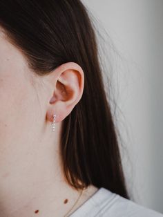 Delicate and dainty, the sterling silver chain attaches to both stud and post to create a unique hugged ear chain design - as unique and beautiful as the wearer.Material: Sterling silver. Hello Adorn makes beautiful minimalist everyday jewelry by hand in Eau Claire, Wisconsin. Classic Pierced Ear Climbers As Gift, Classic Single Ear Climber Earring As Gift, Classic Tiny Sterling Silver Huggie Earrings, Silver Fine Jewelry Ear Climbers, Everyday Sterling Silver Huggie Cartilage Earrings, Modern Hypoallergenic Sterling Silver Cartilage Earrings, Wedding Sterling Silver Ear Climbers Fine Jewelry, Wedding Sterling Silver Ear Climbers, Wedding Fine Jewelry Sterling Silver Ear Climbers