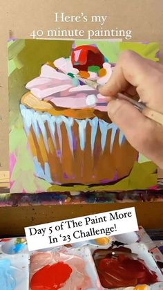 someone is painting a cupcake on the easel with acrylic paint and watercolors