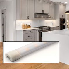 an image of a kitchen setting with white countertops and gray cabinets, including a large roll of paper on the floor