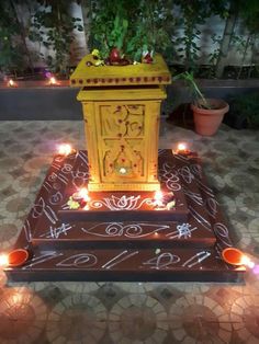 a small shrine with candles lit up on the ground