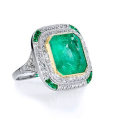 The allure of the Emerald has tantalized cultures for centuries. Known for clarity and thought to bring good vision to its beholders, the Emerald is a stunning gemstone with vibrant color and irresistible visual appeal. This Art Deco Style platinum and 18K yellow gold ring features an impressive 7.44 ct Colombian Emerald and displays a vivacious green hue. Emboldened by extravagance, the lavish center gemstone is hugged by diamonds weighing approximately 1.50 carats accented with 12 pieces of ca Green Platinum Gemstones Fine Jewelry, Fine Green Platinum Gemstones Jewelry, Luxury Gia Certified Emerald Gemstones, Luxury Yellow Gold Gia Certified Gemstones, Luxury Gia Certified Yellow Gold Gemstones, Luxury Gemstone With Center Stone For Anniversary, Luxury Center Stone Gemstone For Anniversary, Luxury Multi-stone Emerald Platinum Ring, Luxury Multi-stone Cushion Cut Ring