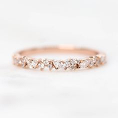 a rose gold wedding band with five diamonds