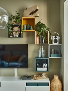 a flat screen tv sitting on top of a white entertainment center