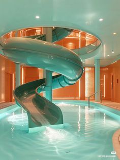 a water slide in the middle of a swimming pool with a spiral staircase leading up to it