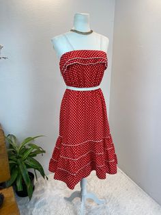 1980s dress / 80s dress / vintage sun dress This is such a cute 1980's, possibly late 1970's dress. She is made from a red and white polka dot cotton with white trim. She has a Double ruffle bodice and a three tiered skirt. For absolute comfort she has an elastic waistband and bodice line. She has two white spaghetti straps and is so adorable. Measurements provided are flat and have been doubled. Bust 34/35" range due to elastic Waist 26-30" suggested range for elastic Hips 40"   Length 41" ❤️ Condition: Excellent vintage condition. Flaw: none found. Belt in photos not included.This item has been cleaned and is ready to wear. $126 includes domestic shipping and insurance. International shipping is $30. Please let me know if you have questions, would like more measurements, or photos. I am Vintage Ruffled Midi Dress For Summer, Retro Summer Dress With Ruffles, Vintage Cotton Midi Dress For Summer, Retro Vintage Midi Dress With Ruffles, Retro Cotton Midi Dress For Summer, Spring Polka Dot Cotton Midi Dress, Retro Polka Dot Lined Dresses, Cotton Retro Midi Dress For Summer, Spring Cotton Midi Dress In Polka Dot