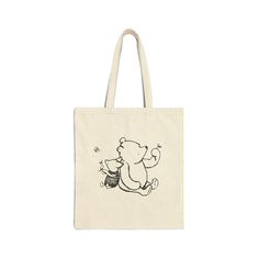 a tote bag with a drawing of a teddy bear on it's back