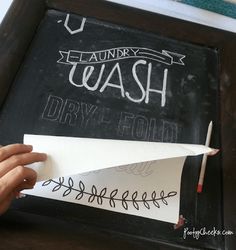 a person holding up a piece of paper with writing on it