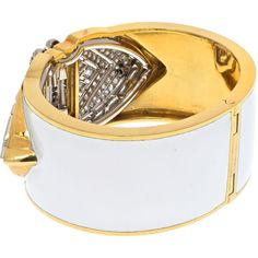 Bask in the brilliance of fine craftsmanship and innovative design with the David Webb Platinum & 18K Yellow Gold White Enamel Shield Diamond Clips Cuff Bracelet. This exquisite piece of jewelry exudes old Hollywood glamour, featuring platinum diamond shield-shaped ends that can be detached and worn as double clips. Adorned with a dazzling array of step-cut and brilliant-cut diamonds, this bracelet is a testament to elegance and sophistication.The design, crafted with white enamel, imbues the piece with a timeless quality, ensuring it remains a cherished heirloom for generations. Measuring around 6 inches in circumference, this bracelet is designed for a small wrist size, making it a perfect fit for those who appreciate bold yet refined accessories. The width of approximately 1.2 inches en David Webb, Step Cut, Old Hollywood Glamour, Hollywood Glamour, Innovative Design, White Enamel, Brilliant Cut Diamond, Old Hollywood, Cuff Bracelet