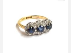 Made by bespoke jewellers, Albion of London, this is truly an amazing quality piece that will be noticed by all.  The ring is made of 18ct gold and set with diamonds and sapphires to for a trio of flower heads. The diamonds are really white and the sapphires are a really good vivid blue colour, better than the photographer has captured.. Perfect condition Ring size UK - K. US 5. 1/4 The front of the ring measures 1.8cm x 0.8cm and sits 0.5 off the finger. Flower Cluster Engagement Ring, Hallmarked Diamond Sapphire Cluster Ring, Diamond Cluster Sapphire Ring Hallmarked, Flower Ring Engagement, Flower Cluster Ring, Fairy Brooch, Flower Engagement Ring, Big Diamond, Cluster Engagement Ring