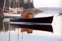 two boats are docked in the water next to each other