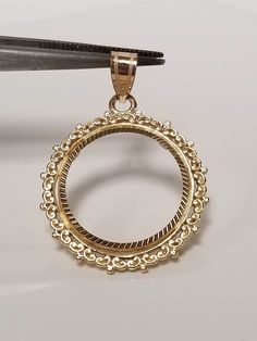 "Thanks for shopping our vintage estate store. We tend to sell well below wholesale and truly hope you enjoy all of our items. Many of the items are one of a kind, so please enjoy scrolling through the pictures and hopefully something will catch your eye. Spots are from reflection or camera. Estate 14k yellow gold bezel holder 1/10-coin rope twist pendant. Works great with any 1/10 gold coins. Length: 1 1/8\" Diam: 3/4\" Weight: 2.34 grams Bail: 3mm Nice 14k coin bezel pendant." Classic Gold Jewelry With Bezel Setting, Luxury Jewelry With Intricate Design And Round Pendant, Intricate Round Pendant Jewelry For Anniversary, Luxury Round Pendant Jewelry With Intricate Design, Classic Filigree Round Pendant Jewelry, Formal Jewelry With Intricate Round Pendant, Yellow Gold Jewelry With Bezel Setting Round Pendant, Heirloom Yellow Gold Jewelry With Bezel Setting, Luxury Jewelry With Filigree And Round Pendant