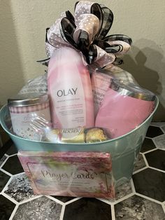 a basket filled with personal care items on top of a tiled floor next to a wall