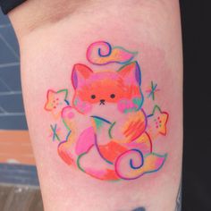 a colorful cat tattoo on the arm