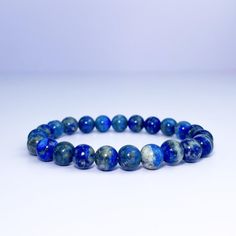 Lapis lazuli is a powerful stone for spiritual growth and enlightenment. This bracelet is designed to help you connect with the wisdom and power of lapis lazuli, and to promote your ongoing spiritual growth. The beautiful blue color of the stone is said to be associated with the divine, and wearing it can help you access your inner guidance and intuition. Blue Lapis Lazuli Gemstone Beaded Bracelet, Spiritual Blue Beaded Bracelets For Meditation, Sapphire Lapis Lazuli Bracelets With Round Beads, Adjustable Blue Crystal Bracelet For Meditation, Spiritual Blue Lapis Lazuli Beaded Bracelets, Spiritual Sapphire Beaded Bracelets With Natural Stones, Sapphire Gemstone Beads Bracelet In Lapis Lazuli, Spiritual Sapphire Beaded Hand-strung Bracelet, Spiritual Sapphire Beaded Bracelets Hand-strung