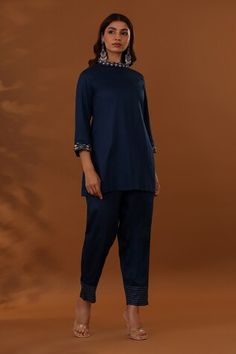 Navy blue top with placed thread embroidered floral patterns. Comes with matching pant. - Aza Fashions Blue Fitted Cotton Pant Set, Blue Embroidered Sets With Straight Pants, Blue Embroidered Pant Set For Diwali, Fitted Blue Embroidered Pant Set, Blue Pant Set With Resham Embroidery, Diwali Pant Set With Resham Embroidery, Semi-stitched, Semi-stitched Blue Sets With Embroidered Border, Navy Blue Top, Band Collar