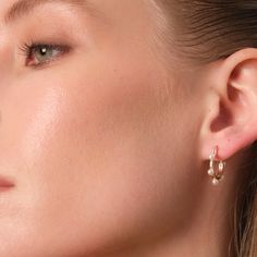 Crafted with 14K Gold Vermeil, Beaming Pearl Hoops boast white Mother of pearl and have dimensions of 18.8mm x 18.2mm, with a weight of 1.3g.With every movement, the pearls dance and shimmer, captivating all who behold them. Feel the weightless elegance as they grace your ears, adding a touch of enchantment to any ensemble. Let the pearls' natural beauty and the hoop's sleek design awaken your imagination and ignite a sense of allure within you. Elevate your style with these scannable delights, Classic Pearl Hoop Jewelry, White Pearl Pendant Hoop Earrings, Elegant Adjustable Small Hoop Pearl Earrings, Gold-plated Hoop Pearl Drop Earrings, Minimalist 14k Gold-filled Hoop Earrings With Pearl Charm, Pearl Hoop Earrings, 14kt Gold, Mother Of Pearl, Gold Vermeil