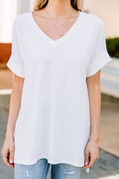 This versatile v-neck tee is here to make your life easy! It's honestly the perfect top for year round styling and layering. You can knot the hem or half tuck into your favorite jeans or shorts. You can layer it with all sorts of jackets, shackets, or kimonos. And don't even get us started on accessories! The options are absolutely endless! This top is truly a staple piece! This top features a v neckline, short cuffed sleeves, and a generous fit. Material has generous amount of stretch. Cam is w White Relaxed Fit V-neck Top, Versatile V-neck Tops For Brunch, White V-neck T-shirt For Everyday, Casual V-neck Top With Short Sleeves For Brunch, Chic White V-neck T-shirt, White Short Sleeve V-neck Top For Everyday, White V-neck Short Sleeve Top, White V-neck Top For Everyday Wear, White V-neck Top For Brunch