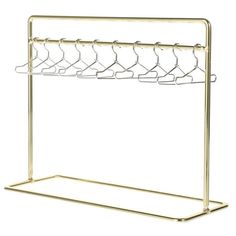 a gold metal rack with five hangers on the top and two rows of clothes hanging