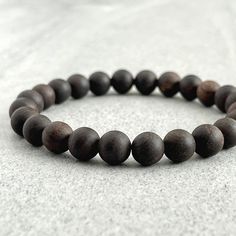 Features: ~ 6mm, 8mm or 10mm Ebony Blackwood beads ~ Strong, non-fraying elastic cord; simply slide bracelet on and off wrist ~ Comes packaged in a re-usable microfiber pouch Please note that despite the name, the colour of this beautiful wood bracelet is actually a dark, rich brown. To ensure the perfect fit, please use the bracelet sizing instructions found in the photo gallery. For more wood beaded bracelets, please use the following link: https://www.etsy.com/ca/shop/FujiBeads?ref=shop_sugg& Slide Bracelet, Wood Bead Bracelet, Brown Bracelet, For Him Gifts, Him Gifts, Wood Bracelet, Tiger Eye Bracelet, Red Tigers Eye, Handcrafted Bracelets