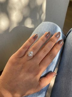 a woman's hand with two rings and a diamond ring on her left hand