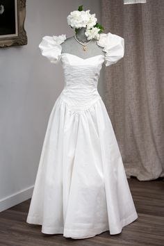 a white dress on display in front of a window