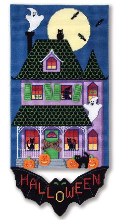 a cross stitch halloween house with bats and pumpkins