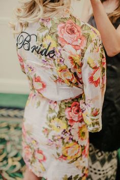 the back of a bridesmaid's robe with flowers on it