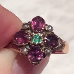 Stunning antique ring set with an amethyst, green paste and white seed pearls, set in 9ct gold, and dated 1876. Here we have a lovely antique ring with the Suffragette colours of purple amethyst for loyalty, white for purity and green for hope. This delightful ring is made in fully hallmarked 9ct gold. The faceted amethyst pastes surround a green faceted paste stone and these are  lovely and  bright. The seed pearls are a lovely creamy white, and they intersperse the amethyst paste. The ring is in a good antique condition and has some slight traces of historical repair on the reverse, some solder, so cannot be resized. As it's an early ring from 1876, I would suggest light wear only. One of the amethyst paste stones has a small chip, and the stones are lightly scratched, just with normal a Vintage 14k Gold Multi-stone Amethyst Ring, Vintage Multi-stone Amethyst Ring In 14k Gold, Vintage Amethyst Ring With Rose Cut Diamonds, Antique Ring Settings, Vintage Indian Jewelry, Antique Ring, Ruby Engagement Ring, Etsy Gold Ring, Lovely Ring