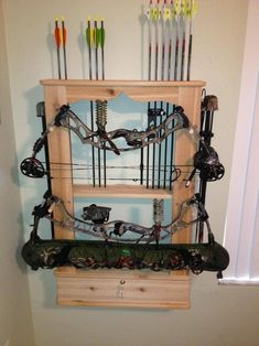 the bow rack is made out of wood and has many different types of arrows on it