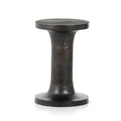 a small black stool sitting on top of a white floor