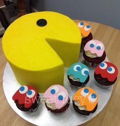 there are cupcakes on the plate with one piece cut out to look like a pacman