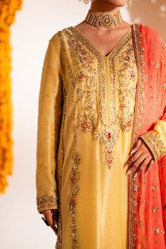 Yellow Mehndi Dress in Kameez Trouser Dupatta Style is a traditional masterpiece that will give you a head-turning flawless look on the big day. Hand-crafted details of tilla, dabka, sequins, and gota make this stunning Pakistani Dress an epitome of beauty and your foremost priority. Yellow Kameez: The kameez in an alluring yellow color is beautifully embellished with zardosi, tilla, dabka, and Resham. The stunning details of gota give a traditional touch to this beautiful kameez. Embellished neckline and borders make this kameez a perfect choice to wear on Mehndi. Kameez Trouser: The Embellished yellow kameez is paired with trousers, creating a lavish Pakistani Mehndi Dress. The borders of these trousers are hand-embellished, giving a heritage traditional touch to this overall attire in p Semi-stitched Gold Kurta With Naqshi, Bollywood Style Sharara With Naqshi For Reception, Floor-length Naqshi Sharara For Reception, Floor-length Raw Silk Dupatta With Naqshi Detail, Wedding Salwar Kameez With Naqshi Detail, Anarkali Sharara With Naqshi For Reception, Floor-length Salwar Kameez With Naqshi For Weddings, Floor-length Lehenga With Naqshi For Reception, Floor-length Naqshi Lehenga For Reception