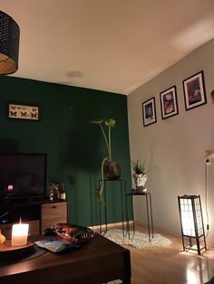 a living room filled with furniture and a flat screen tv sitting on top of a hard wood floor