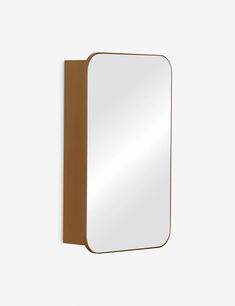 a mirror that is on the wall with a wooden frame and brown leather border around it