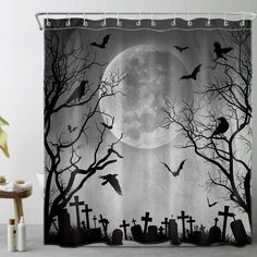 a halloween themed shower curtain with bats and tombstones in front of a full moon