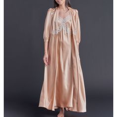 The lovely Maia dressing gown features a 100% silk charmeuse body with custom 18K gold twice-plated buttons at the robe waist and sleeve for closure. There is a feminine French lace appliqué detail at the back of the waist and also at the front of the waistband, and a soft billow to the three-quarter length sleeve. Product Details 100% silk charmeuse. 18k gold twice-plated buttons. Made in the USA. Care Instructions We recommend hand-laundering your LFrank lingerie using a delicate detergent or lingerie-specific wash in cold water. Please hang or lay flat to dry, and steam as necessary. Dry cleaning is also an option, if you prefer. Size & Fit This item fits true to size. Shipping Details Please allow 3 weeks for production and 5-7 days for standard delivery. Return Policy This item is ava Silk Maxi, Silk Robe, Alt Fashion, Silk Charmeuse, Dressing Gown, French Lace, Lace Applique, Three Quarter, Night Gown