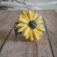 Sunflower Ring: Something boho chic for a Summer Festival, Matching sets for your beautiful bridesmaids on your summer wedding day, or just something fun to fit your vintage inspired wardrobe! This ring is the perfect fit to your needs.  This lovely sunflower ring is fully adjustable. The flower is attached using a high grade epoxy resin to ensure durability!  Each item in our shop is carefully handcrafted with love and attention to detail. Some items are delicate in nature and should be taken c Yellow Flower Wedding Rings, Yellow Flower Ring For Wedding, Adjustable Sunflower Design Flower Ring Gift, Bohemian Flower Ring As A Gift, Bohemian Flower Ring For Promise, Handmade Flower Shaped Ring For Wedding, Wedding Jewelry With Sunflower Design, Adjustable Yellow Flower Ring For Gift, Bohemian Flower Wedding Ring