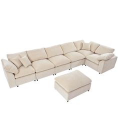 a large sectional couch with footstool and ottoman in cream colored upholstered fabric