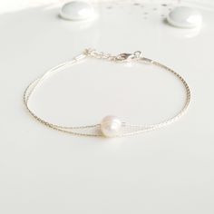 "Minimalist, wearable and delicate 925 sterling silver chain bracelet with natural pearl gemstone for everyday wearing. Length: from 5,5\" to 8\" with 2\" 925 sterling silver extensor chain. Width: 6-7mm single irregular pearl. Material: 925 sterling silver chain and strong lobster clasp. Handmade in Spain. Ideal for a gift to silver jewelry lovers. All our products are presented in a white organza bag. If you want a different color scheme, ask us and we will design it for you :) ♡ Made with lov Delicate Sterling Silver Bracelet With Adjustable Chain, Gift White Gold Bracelet With Pearl Drop, Minimalist Pearl Bracelet With Adjustable Chain, Adjustable Sterling Silver Pearl Bracelet For Gift, Adjustable Sterling Silver Bracelet With Pearls For Gift, Adjustable Minimalist Pearl Bracelet, Minimalist Silver Pearl Bracelet With Adjustable Chain, Adjustable Sterling Silver Pearl Drop Bracelet, Minimalist Adjustable Pearl Chain Bracelet