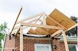 an unfinished roof on a brick house