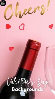 a bottle of wine sitting next to a glass on top of a pink background with hearts