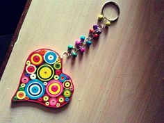 a colorful heart shaped keychain on top of a wooden table