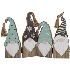 three wooden gnomes with hats and scarves