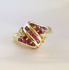 This is a cluster Ruby and diamond ring.  6 pieces of diamonds total weight 0.18 carats.  19 pieces of rubies total weight 0.85 carats.  14kt yellow gold ring weight 4.7 grams. Diamond Cluster Ruby Ring With Diamond Accents, Red Cluster Diamond Ring In 14k Gold, Red Diamond Cluster Ring In 14k Gold, Cluster Ruby Rings With Diamond Accents, Ruby Cluster Rings With Diamond Accents, Yellow Gold Cluster Ruby Ring, Cluster Ruby Ring In Yellow Gold, Yellow Gold Ruby Ring With Diamond Accents, Gold Ruby Ring With Rose Cut Diamonds Cluster