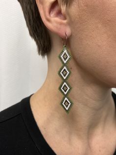 a close up of a person wearing some kind of earrings